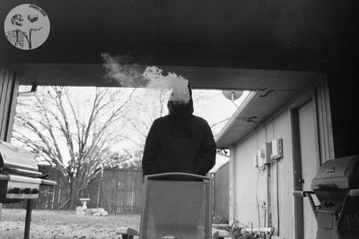 Rear view of man standing in front of building