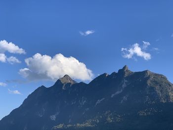 Scenic view of mountains against blue sky