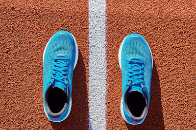 Blue running sneakers at stadium track