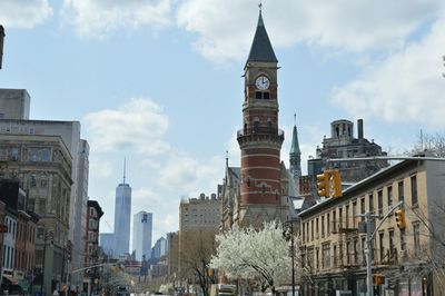 Low angle view of buildings against cloudy sky