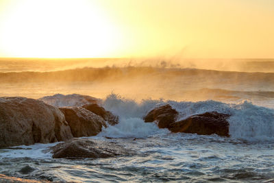 Scenic view of sea against clear sky during sunset