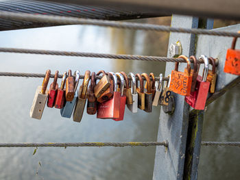 Close-up of padlocks hanging on railing