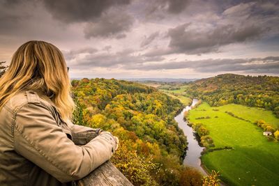 Woman overlooking countryside landscape