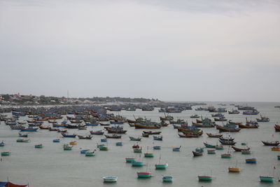 High angle view of townscape by sea against sky