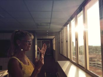 Young woman using mobile phone at home