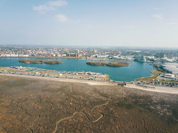 Scenic view of sea and city against sky