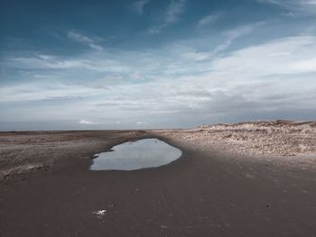 View of sandy shore against the sky