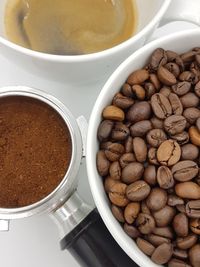 High angle view of coffee beans in bowl on table