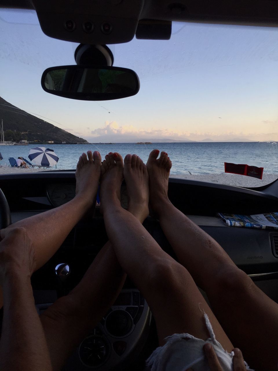 lifestyles, person, sitting, leisure activity, part of, sea, relaxation, personal perspective, holding, cropped, sky, men, human finger, transportation, technology, smart phone