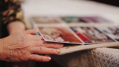 Cropped image of senior woman with photo album