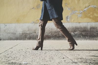 Low section of woman standing on tiled floor