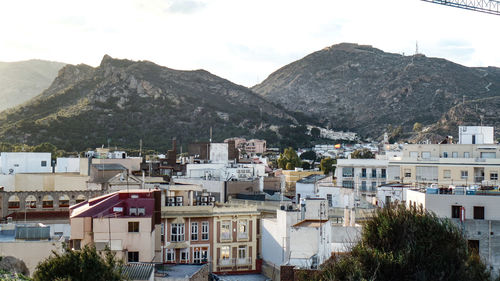 Buildings in town against mountains