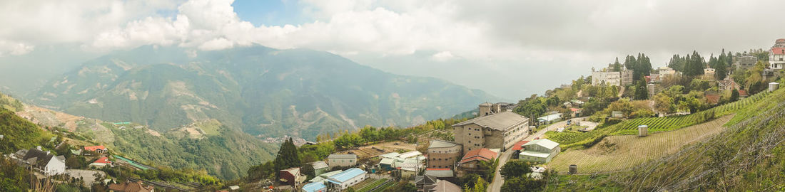 Panoramic view of trees and mountains against sky