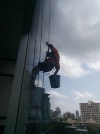 Low angle view of a woman standing against clear sky