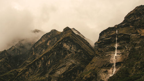 Low angle view of mountain range against sky