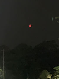 Low angle view of moon in sky at night