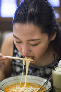 Close-up portrait of woman holding food