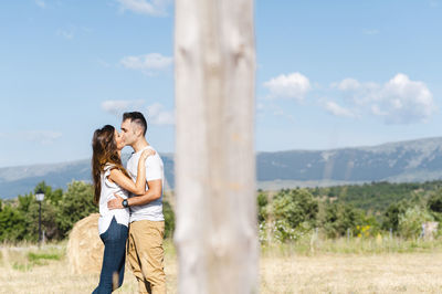 Side view of woman standing against sky