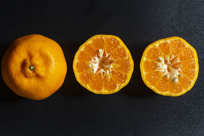 Close-up of orange slices on black background