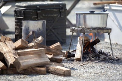 Burning firewood below stove at campsite