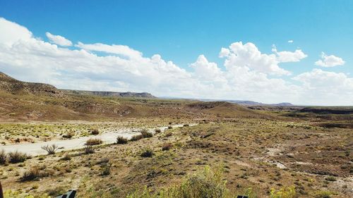 Panoramic view of field against sky