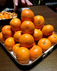 Close-up of orange fruits in plate on table