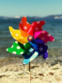 Close-up of multi colored pinwheel toy at beach