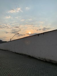 Scenic view of street against sky during sunset