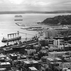 High angle view of cityscape by sea against sky