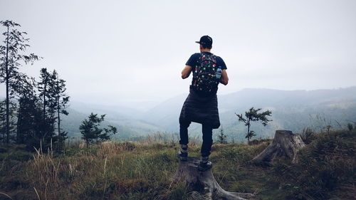 Rear view of woman standing on mountain