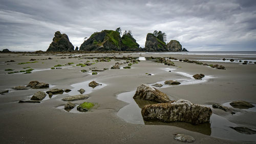 Rocks on beach against sky