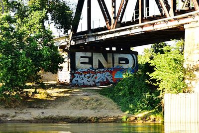 Arch bridge over river against building