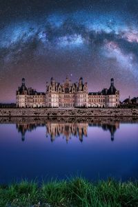 Reflection of buildings in city at night