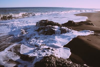 Scenic view of sea with rocks in background