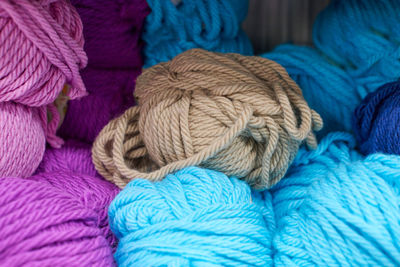 Multicolored yarn balls in knitting shop center, close up. a lot of color yarn for knitting