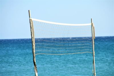 View of net in sea against clear sky