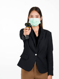 Portrait of a beautiful young woman with mask over white background