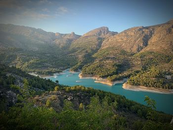 Scenic view of lake and mountains against sky