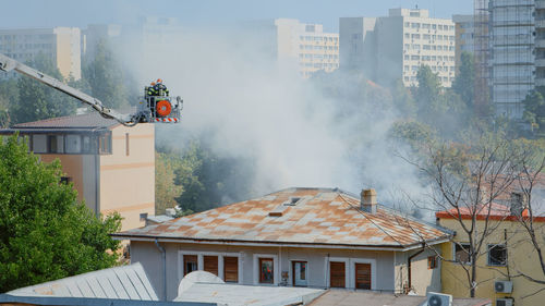 Houses against buildings in city