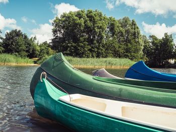 Boat moored on shore against sky