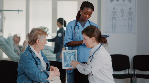 Doctor showing medical x-ray to patient