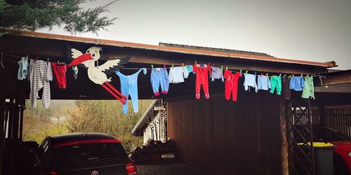 Clothes drying outside house against sky