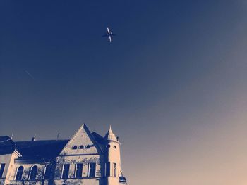 Low angle view of helicopter against clear sky