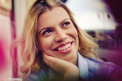 Close-up of smiling woman looking away