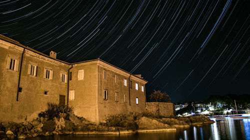 Illuminated building against sky at night