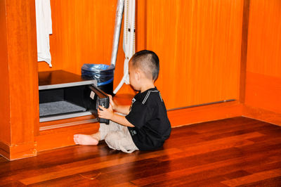 Boy opening drawer at home