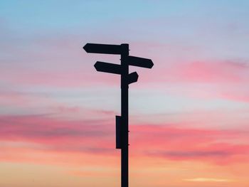 Low angle view of silhouette cross against sky during sunset