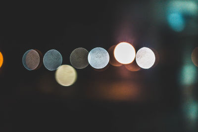 Close-up of illuminated electric lights against sky