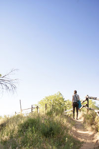 Rear view of man against clear sky