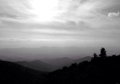 Scenic view of mountains against cloudy sky